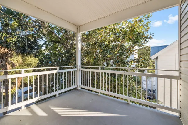 a view of a balcony with wooden fence and floor