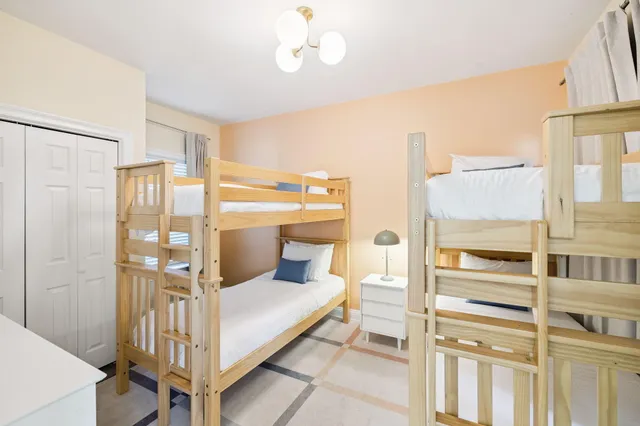 a en suite bathroom with a granite countertop sink and a mirror