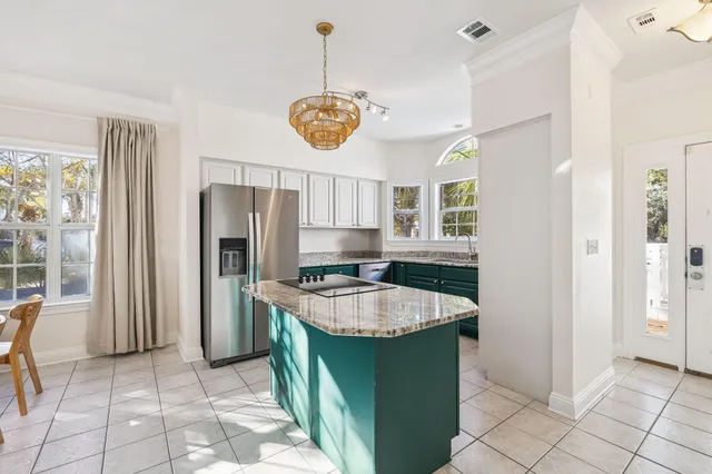 a kitchen with stainless steel appliances granite countertop a sink and a window