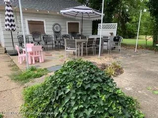 a view of a chairs and tables in backyard of the house
