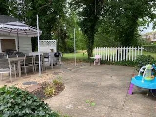 a view of a chairs and table in the back yard