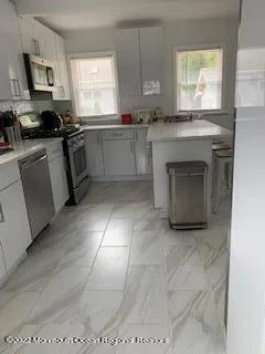 a kitchen with stainless steel appliances a stove sink and cabinets