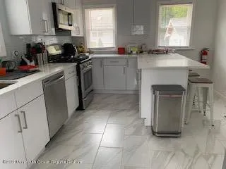 a kitchen with a sink cabinets and window
