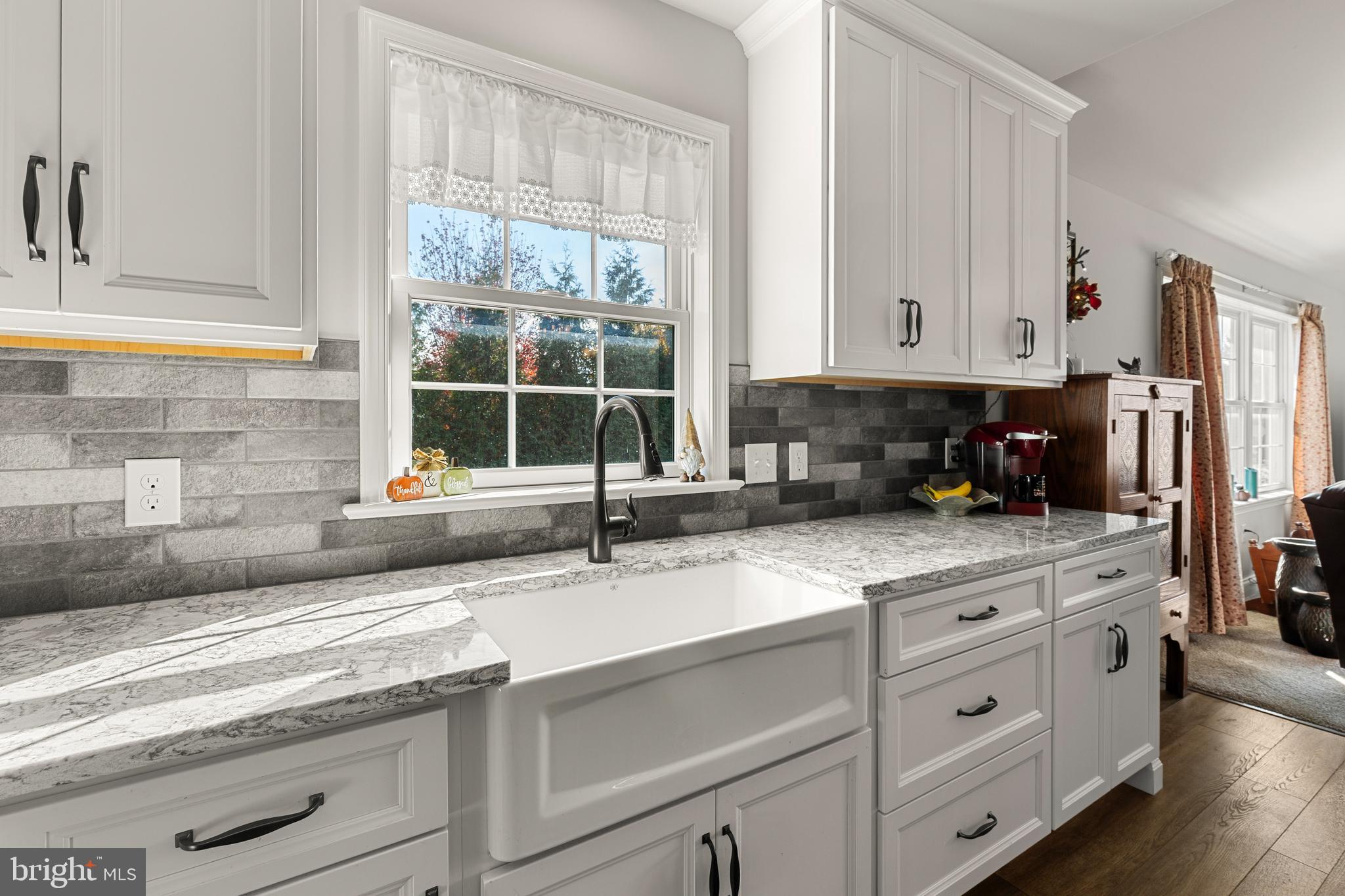 212 Scenic Ridge Boulevard Lebanon, PA 17042 - Photo 6 of 33 a kitchen with granite countertop a sink white cabinets and a window