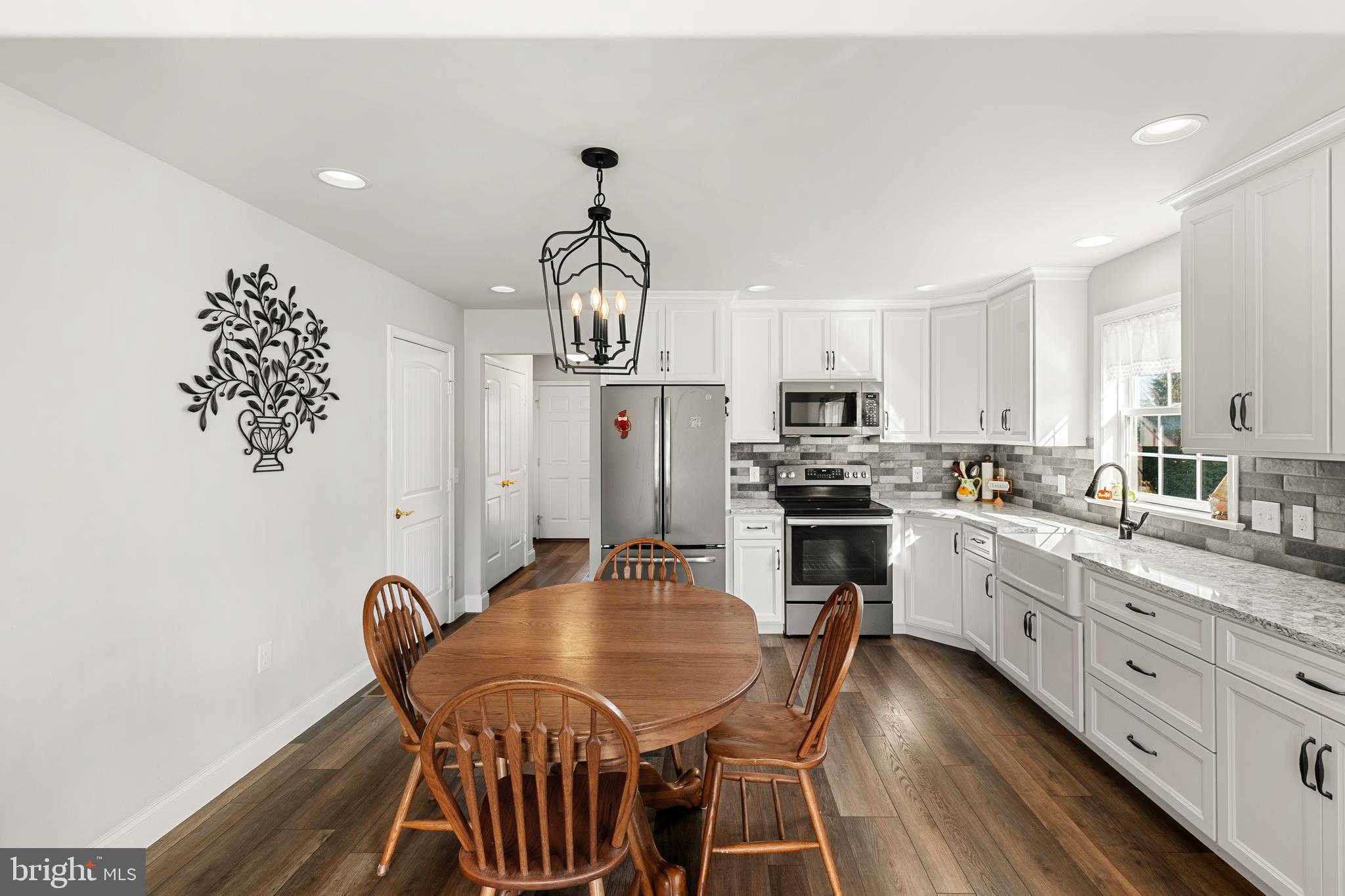 212 Scenic Ridge Boulevard Lebanon, PA 17042 - Photo 7 of 33 a kitchen with kitchen island a dining table chairs stainless steel appliances and cabinets