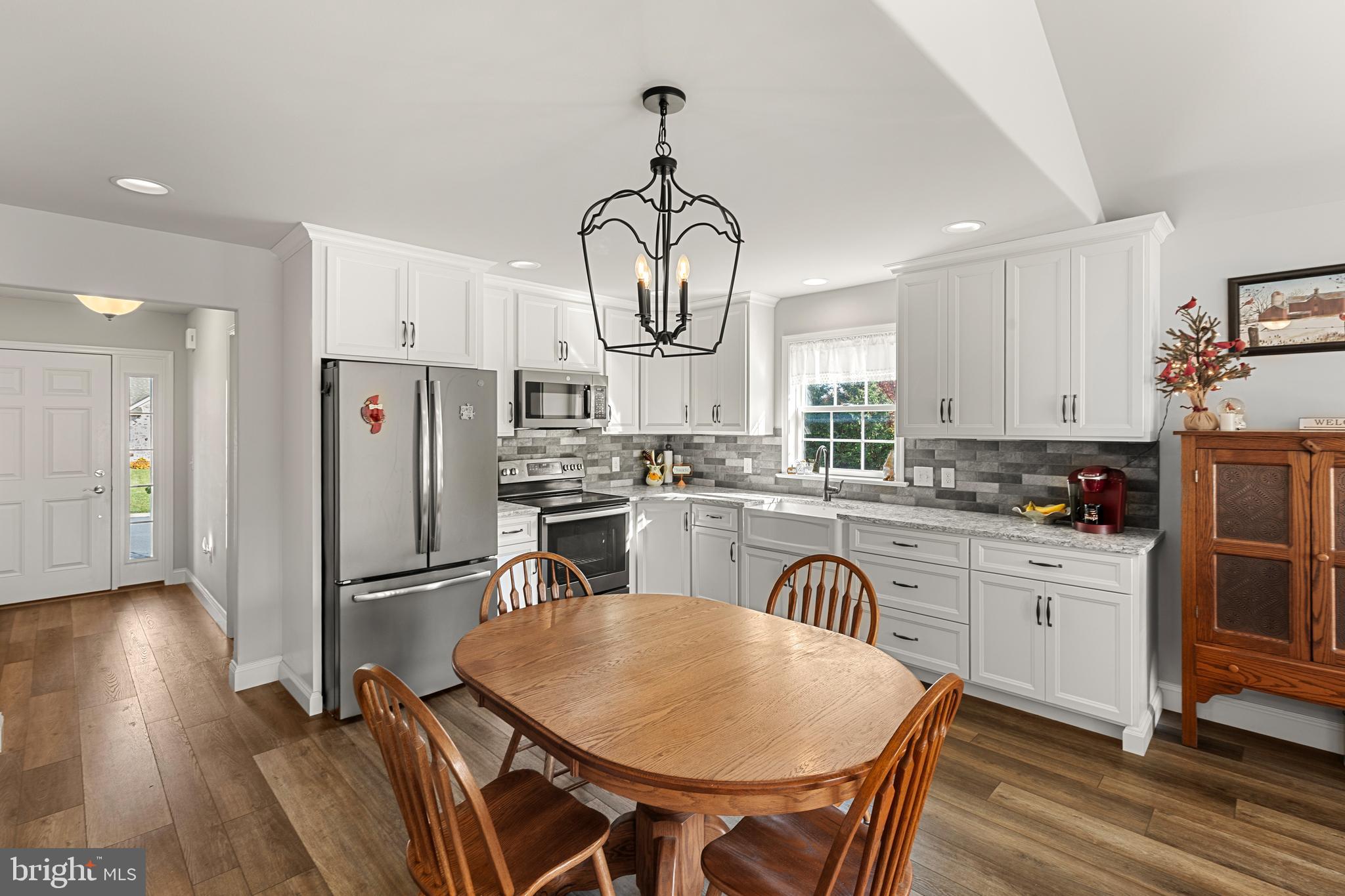 212 Scenic Ridge Boulevard Lebanon, PA 17042 - Photo 8 of 33 a kitchen with stainless steel appliances granite countertop a refrigerator a stove a sink dishwasher and white cabinets with wooden floor