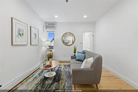 a living room with furniture and a clock