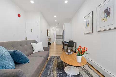 a living room with furniture and a dining table