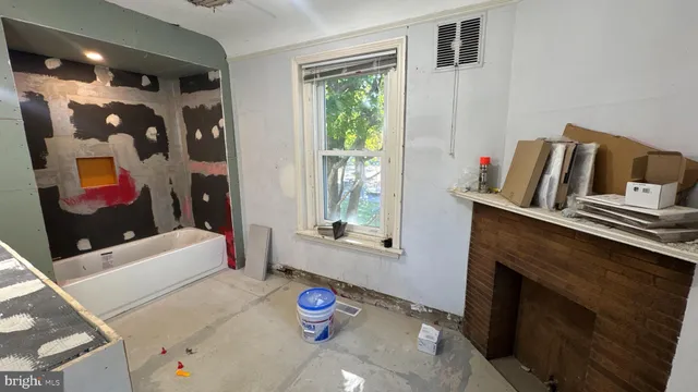a view of a hallway with wooden floor and stairs