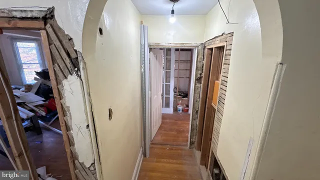 a view of a room with wooden floor and glass door