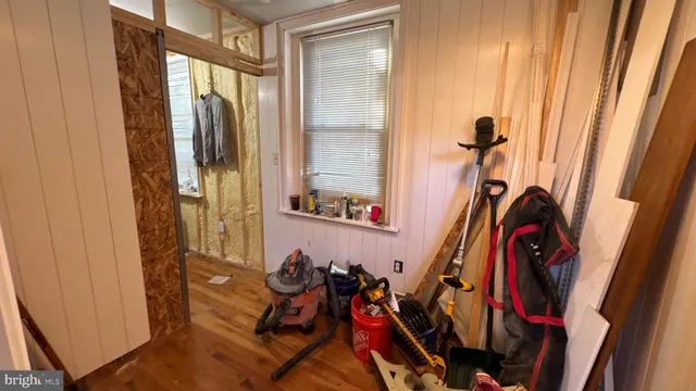 a view of walk in closet with clothes