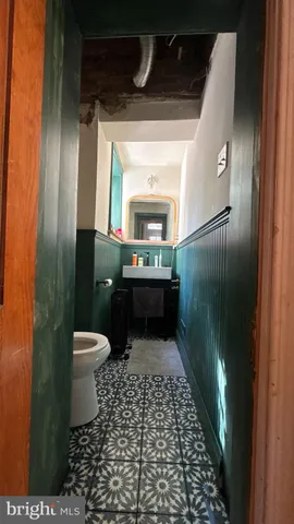 a bathroom with a toilet and a mirror