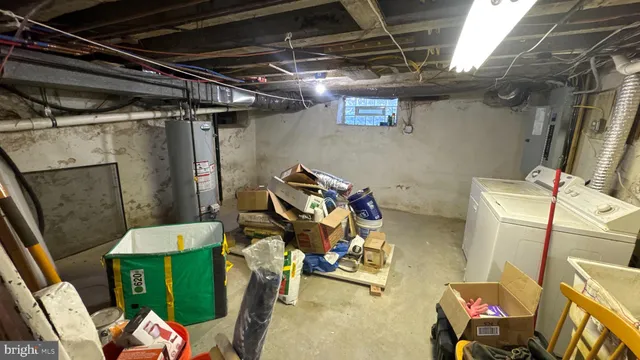 a utility room with dryer washer and stair