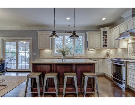 52 Baker Place Newton, MA 02462 - Photo 4 of 24 a kitchen with kitchen island granite countertop a table chairs stove and cabinets