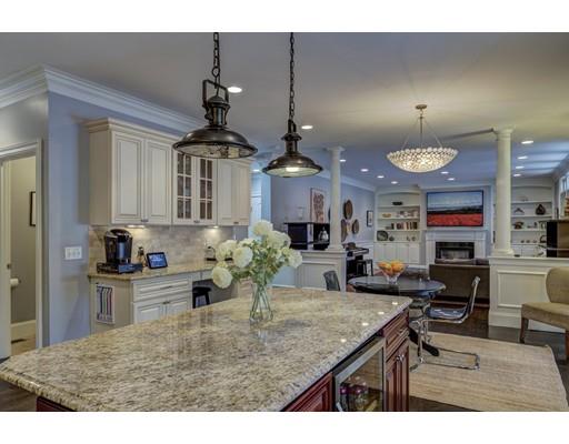 52 Baker Place Newton, MA 02462 - Photo 5 of 24 a kitchen with kitchen island granite countertop a stove a sink a oven dining table and chairs