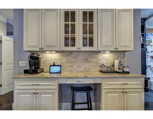 52 Baker Place Newton, MA 02462 - Photo 6 of 24 a kitchen with stainless steel appliances granite countertop a sink stove and cabinets