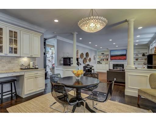 52 Baker Place Newton, MA 02462 - Photo 9 of 24 a kitchen with stainless steel appliances kitchen island granite countertop a dining table chairs and a refrigerator