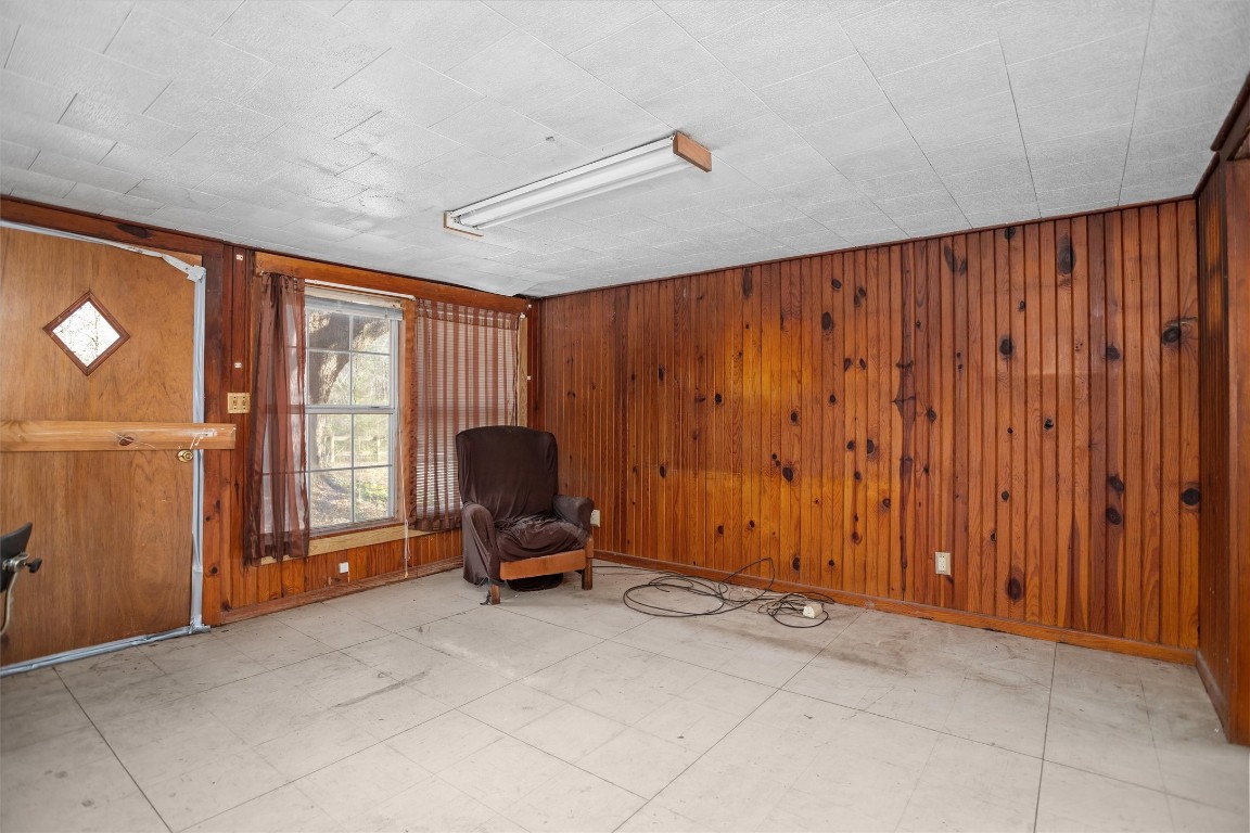 a view of a room with a large window and lounge chair