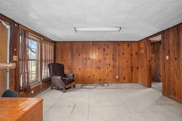 a view of room with lounge chair and windows