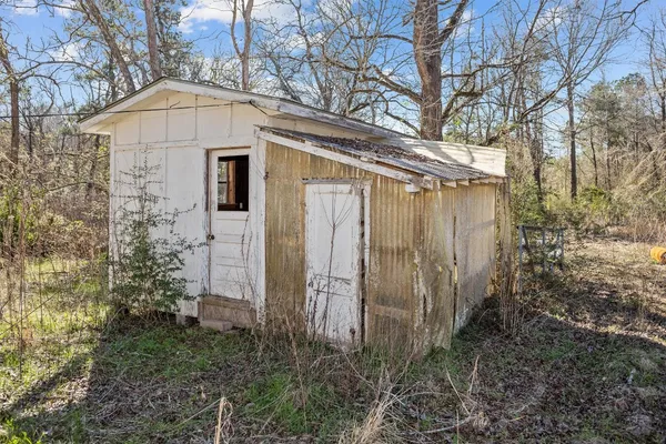 a brick house with tree in front of it