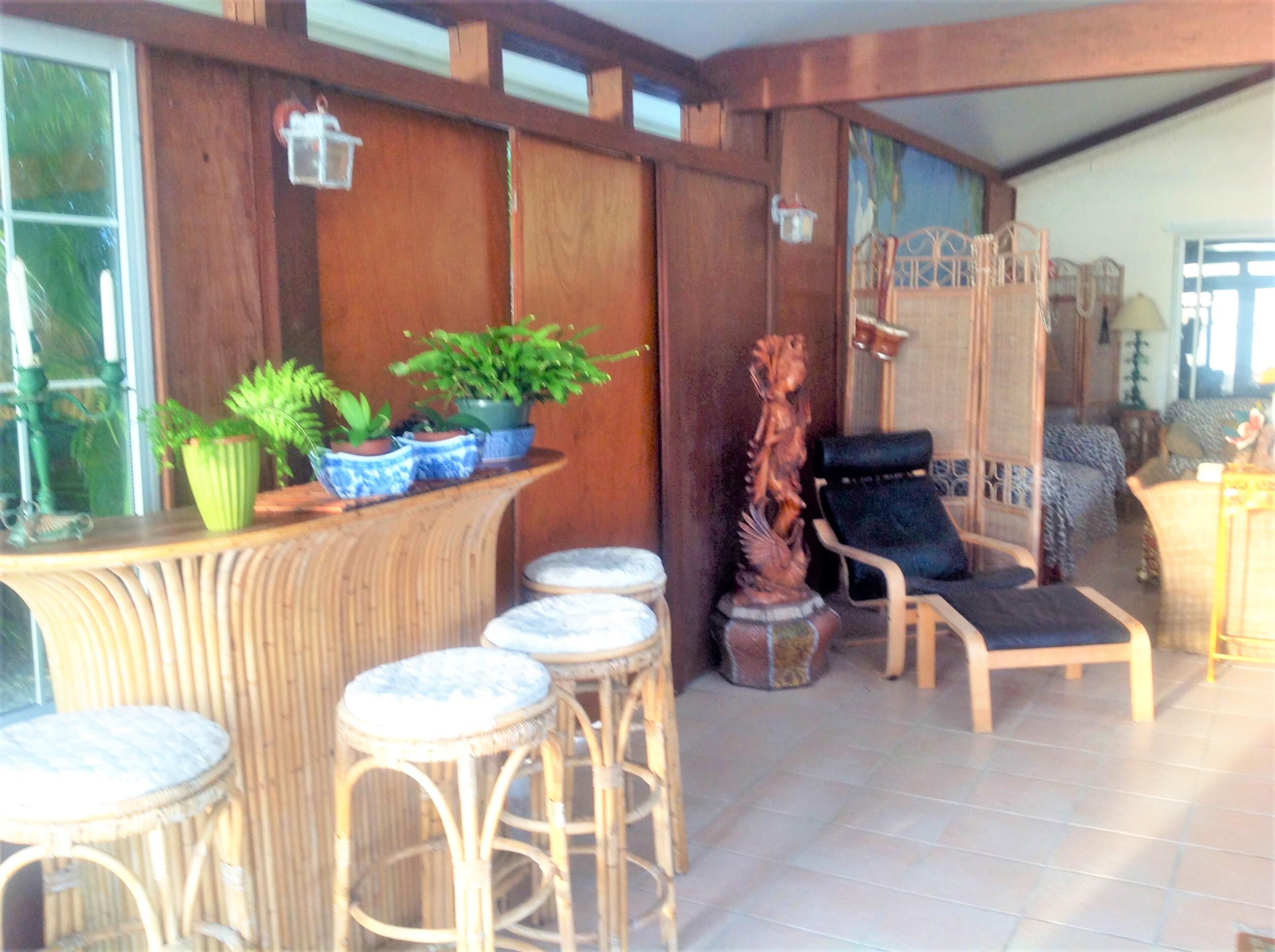 31 Boulder Drive Key West, FL 33040 - Photo 16 of 36 a view of a dining room with furniture a potted plant and wooden floor