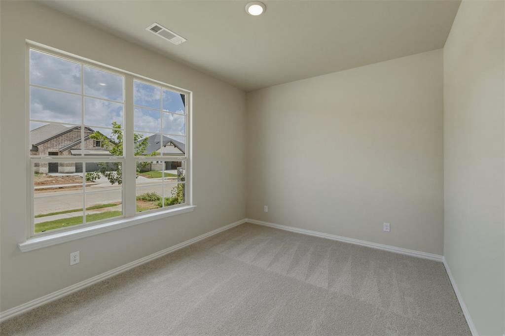 1232 Colca Drive Springtown, TX 76082 - Photo 10 of 23 Bright interior space featuring a large multipane window, light neutral wall paint, recessed lighting, and soft carpet flooring