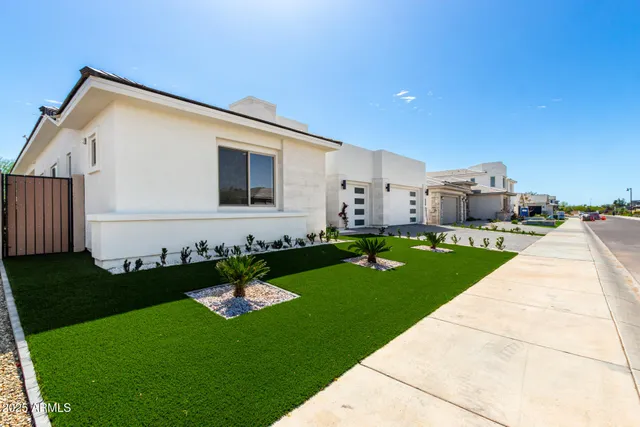 a front view of a house with a garden and yard