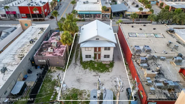 an aerial view of multiple houses with a yard