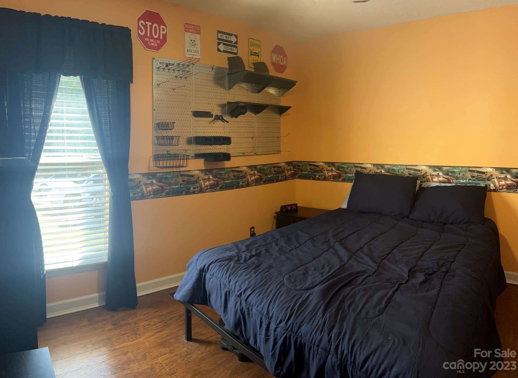 20909 Highway 9 Mount Croghan, SC 29727 - Photo 19 of 21 a bed sitting in a bedroom next to a window with wooden floor
