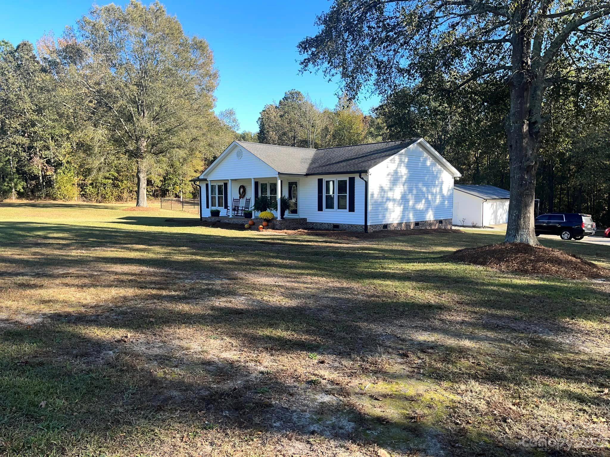 20909 Highway 9 Mount Croghan, SC 29727 - Photo 3 of 21 a front view of a house with a garden