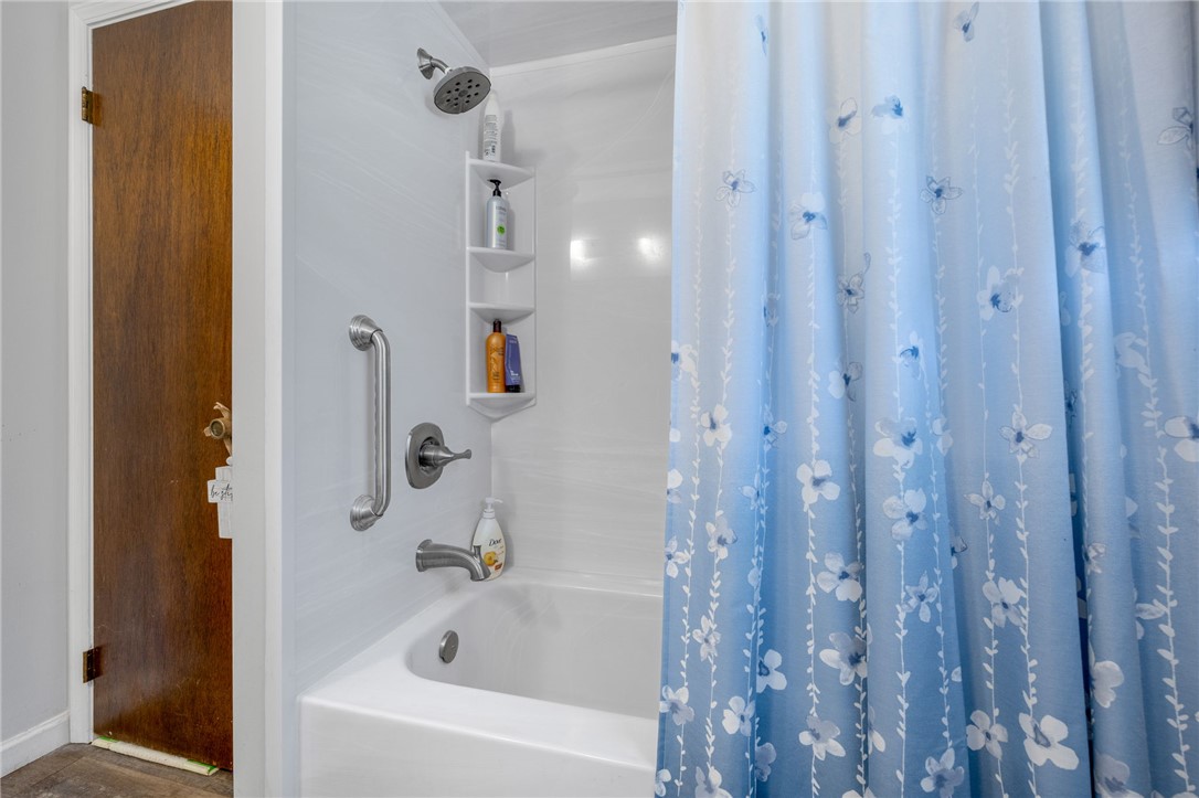131 Bowen Road Anderson, SC 29621 - Photo 25 of 36 A classic bathtub and shower combination sits adjacent to a warm wood door.