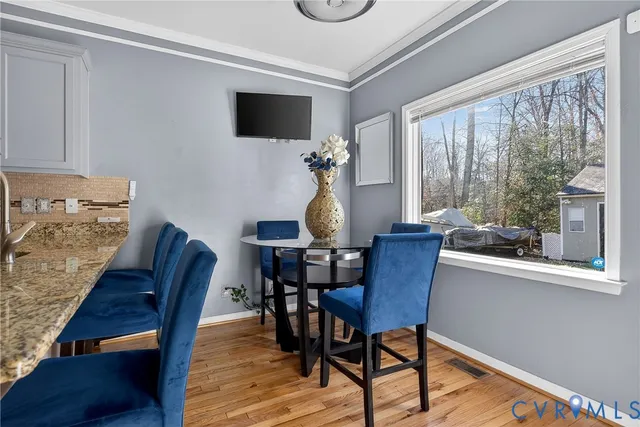 a dining room with furniture and window