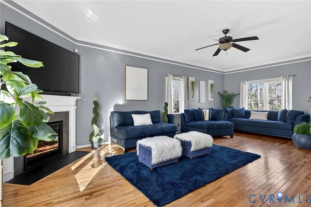 a living room with furniture fireplace and a window