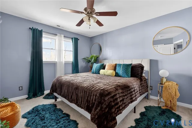 a bedroom with a bed mirror and window