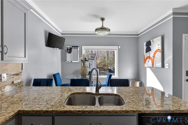 a kitchen with granite countertop a sink and a counter top space