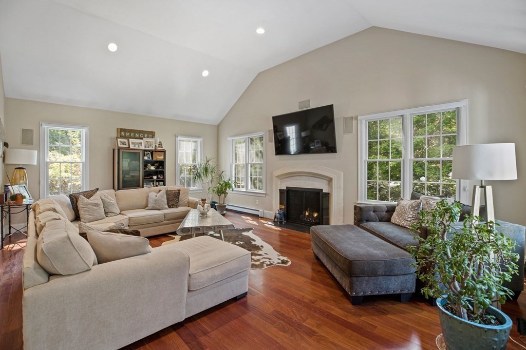 352 Clapp Road Scituate, MA 02066 - Photo 12 of 41 a living room with furniture a fireplace and a flat screen tv