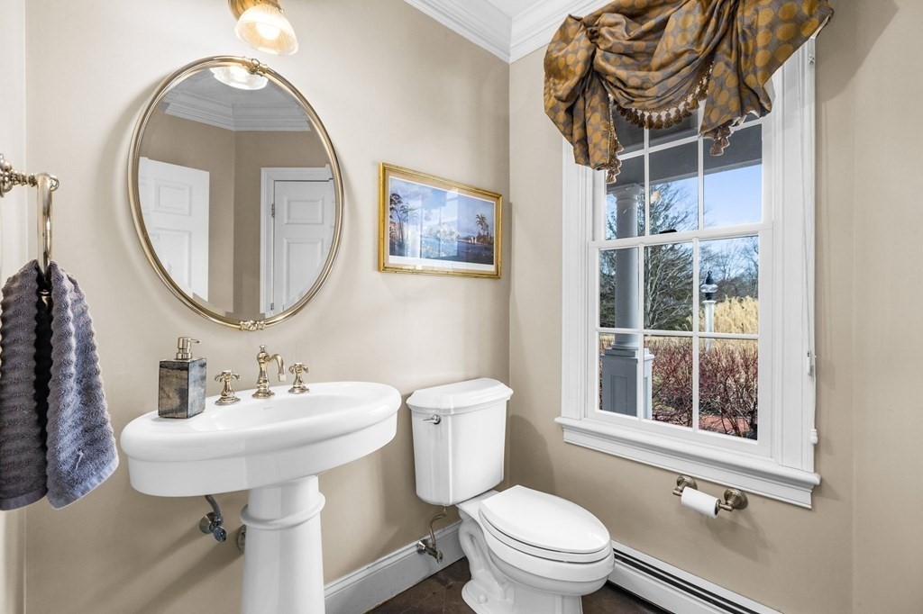 352 Clapp Road Scituate, MA 02066 - Photo 15 of 41 a bathroom with a toilet a sink and a mirror