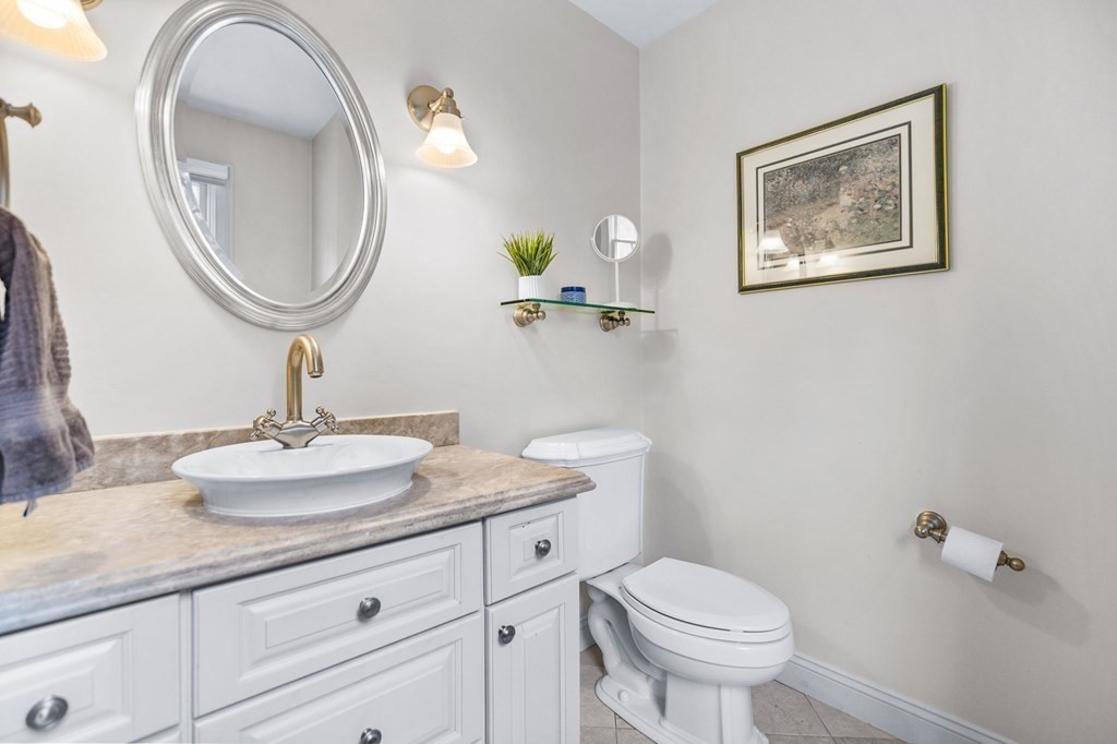 352 Clapp Road Scituate, MA 02066 - Photo 22 of 41 a bathroom with a toilet a sink and mirror