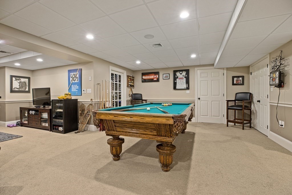 352 Clapp Road Scituate, MA 02066 - Photo 28 of 41 a living room with furniture gym equipment and a refrigerator