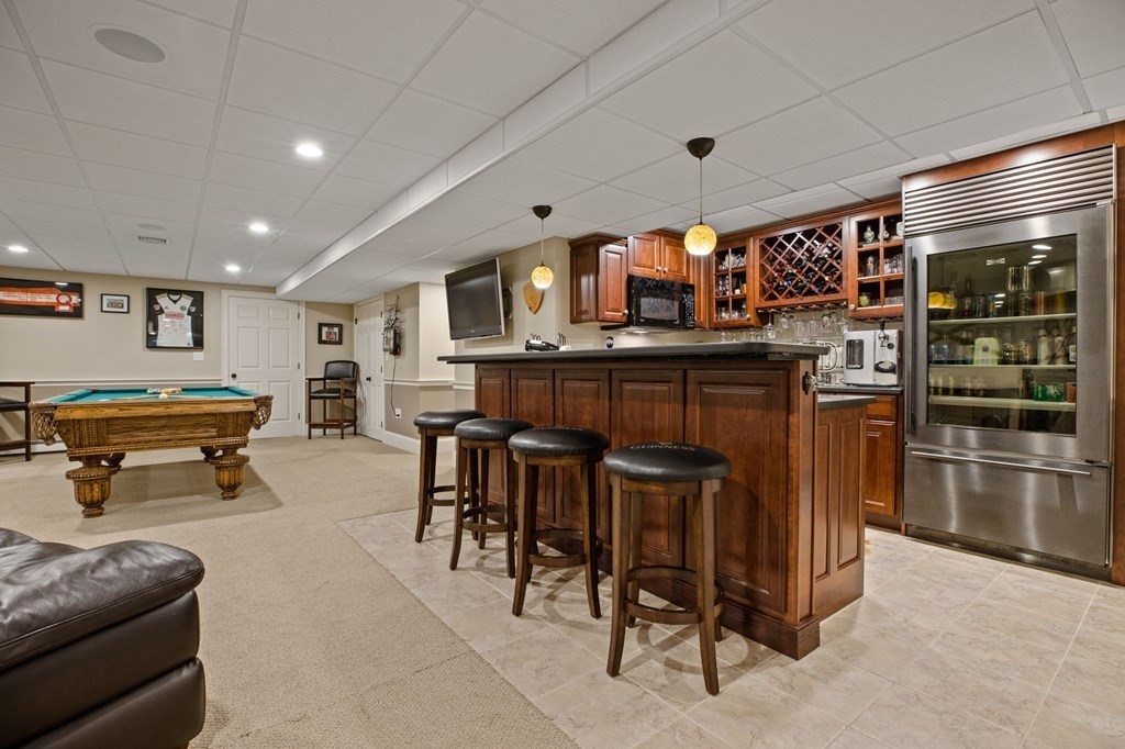352 Clapp Road Scituate, MA 02066 - Photo 30 of 41 a living room with stainless steel appliances furniture a rug and a kitchen view