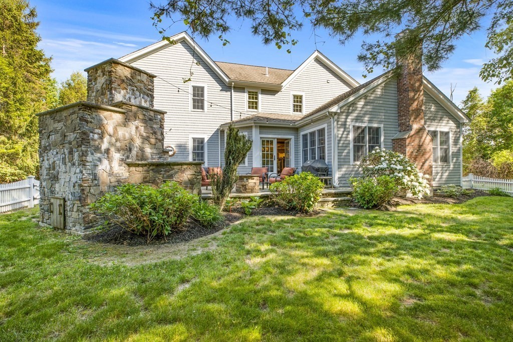 352 Clapp Road Scituate, MA 02066 - Photo 36 of 41 a view of a white house next to a yard with plants and trees