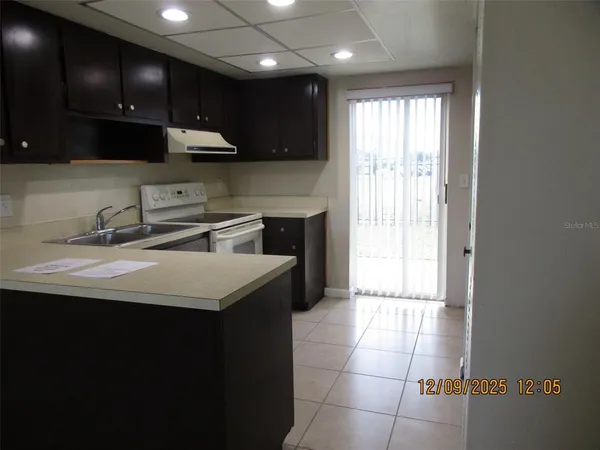 a kitchen with a sink cabinets and stainless steel appliances