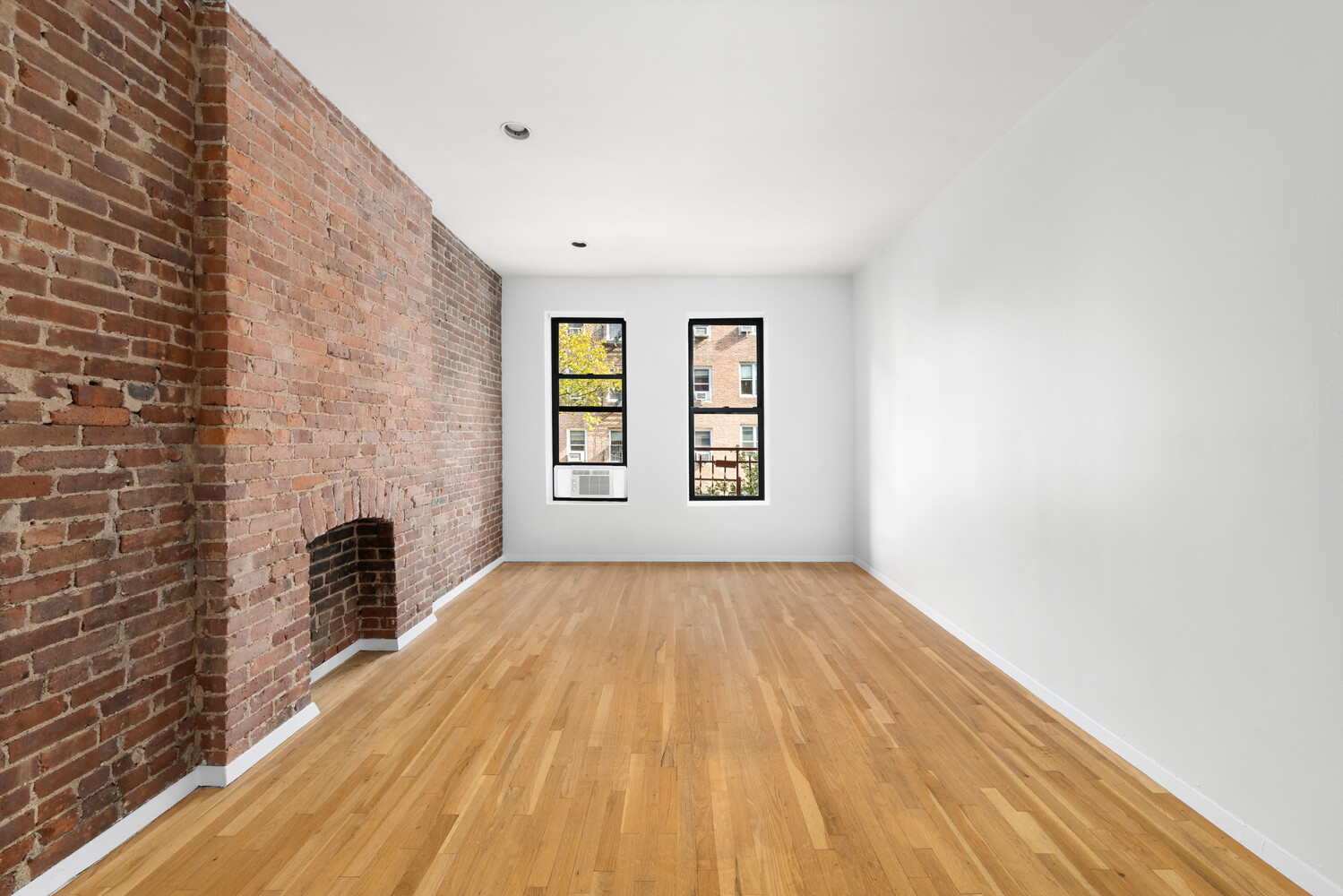 332 East 77th Street, Unit 11 Manhattan, NY 10075 - Photo 2 of 11 a view of an empty room with a window and wooden floor