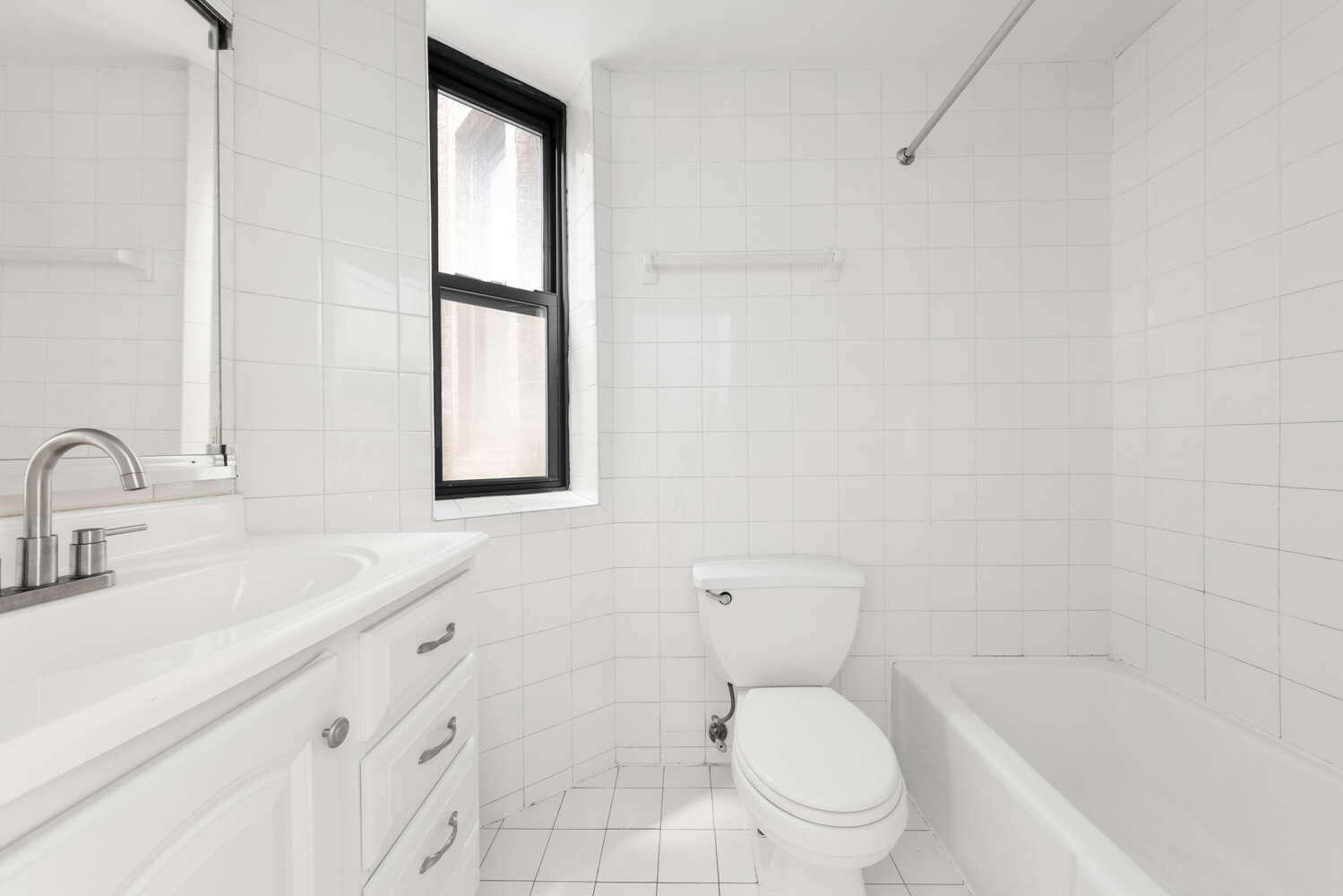 332 East 77th Street, Unit 11 Manhattan, NY 10075 - Photo 6 of 11 a bathroom with a toilet sink and mirror
