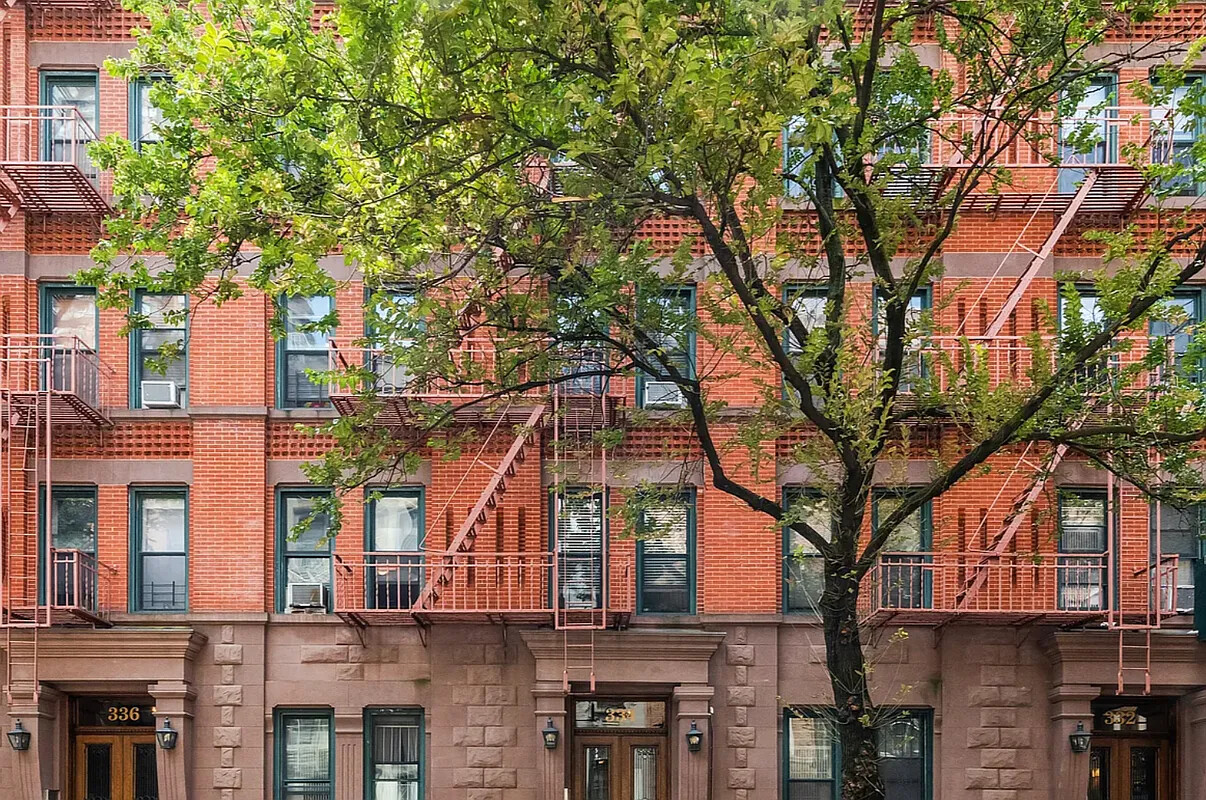 332 East 77th Street, Unit 11 Manhattan, NY 10075 - Photo 7 of 11 a front view of a building with large trees