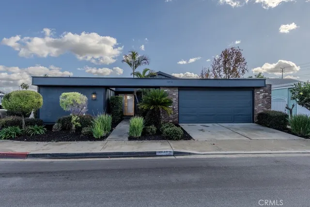 a front view of a house with potted plants
