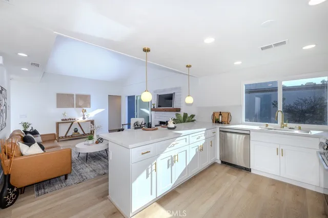 a large kitchen with stainless steel appliances lots of counter space and a sink