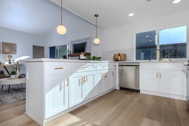 a kitchen with cabinets a sink and appliances