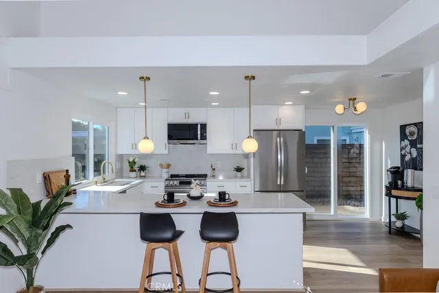a kitchen with counter space cabinets and living room view