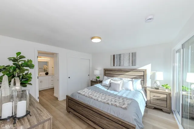 a bedroom with a bed and a potted plant